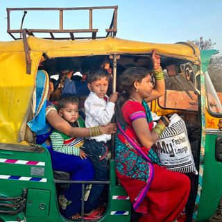 Tuk Tuk, the most convenient vehicle in India. See how many people inside?